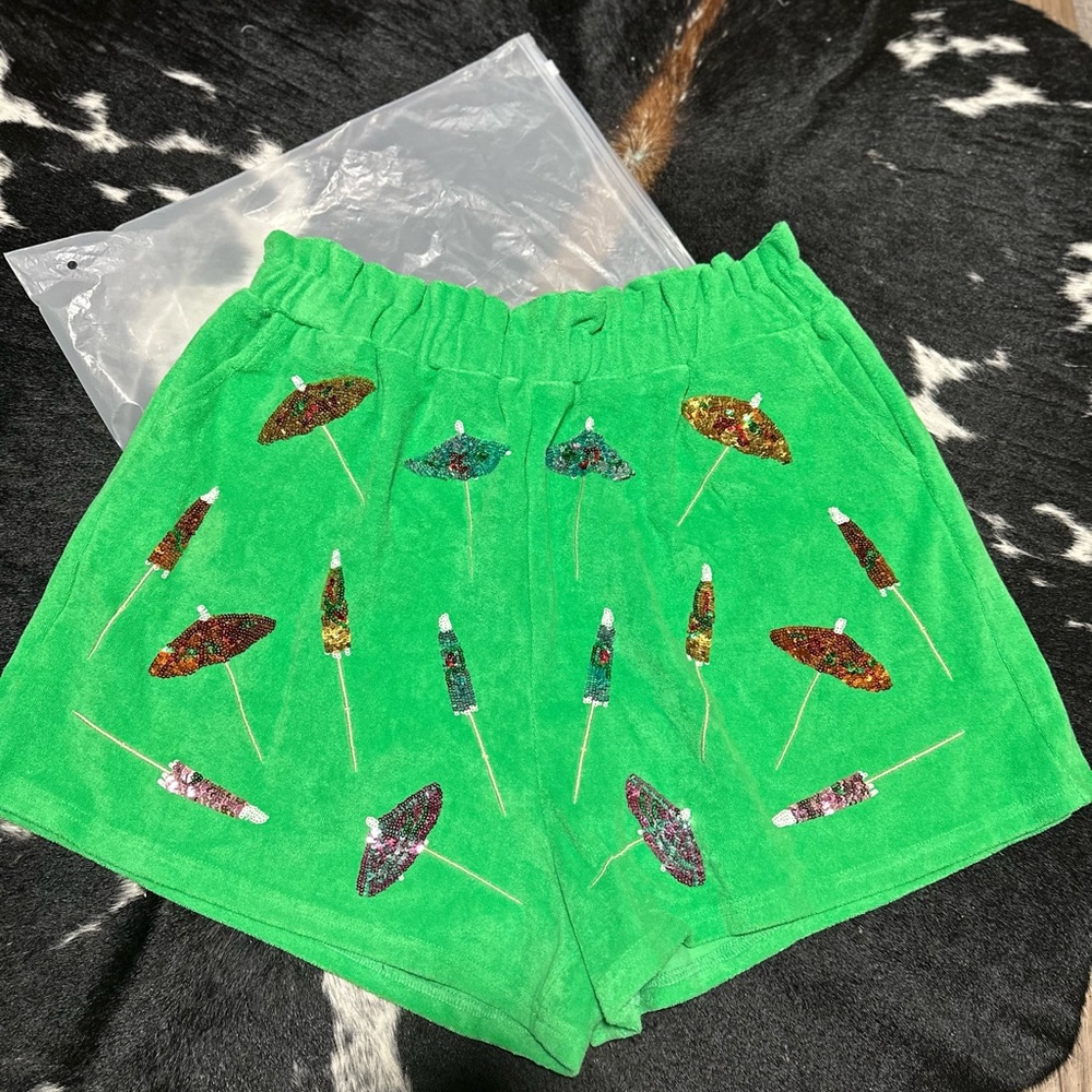 QOS size large green terry cloth shorts with umbrella detail! NWOT in bag.